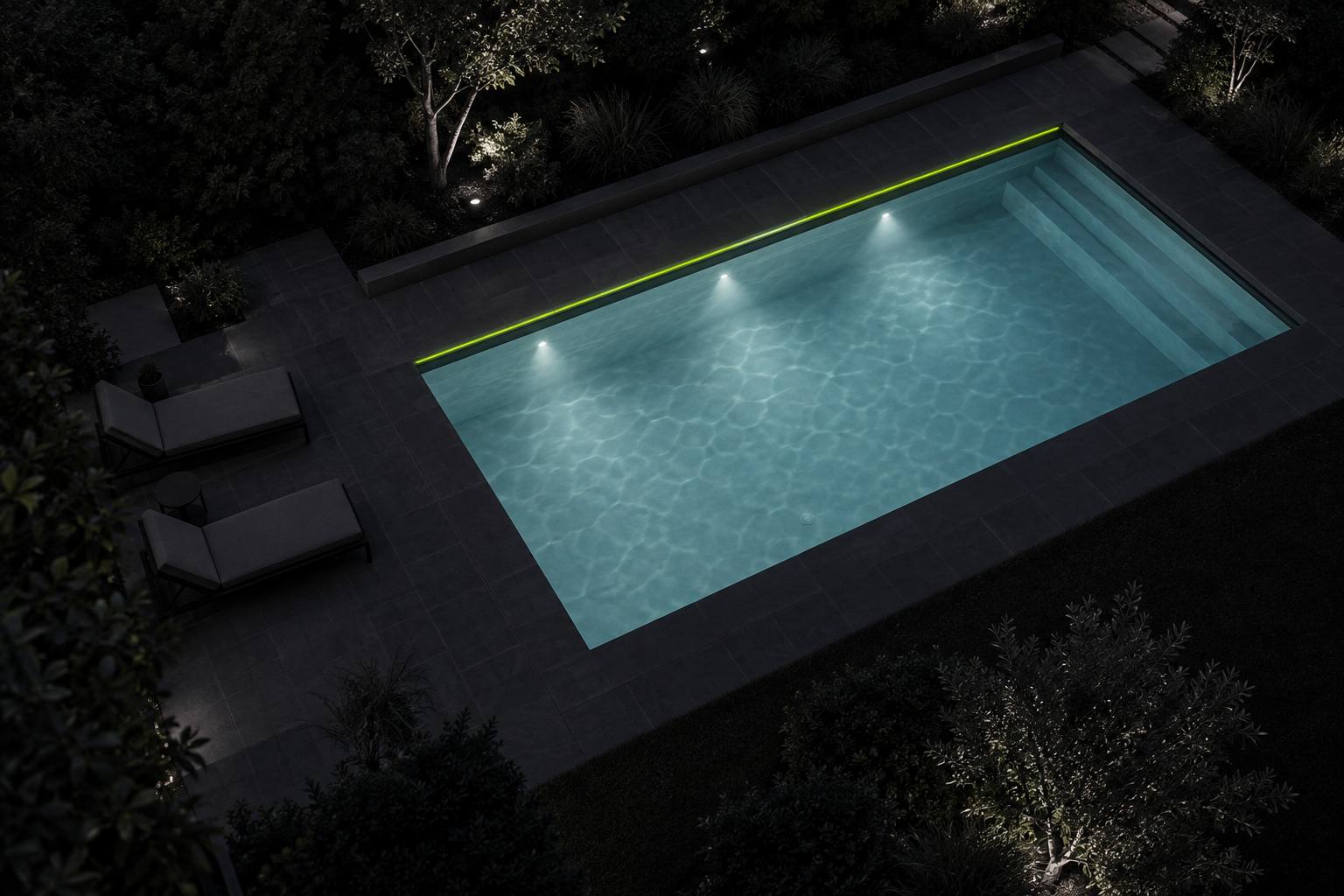 A backyard swimming pool at night, lit from below.